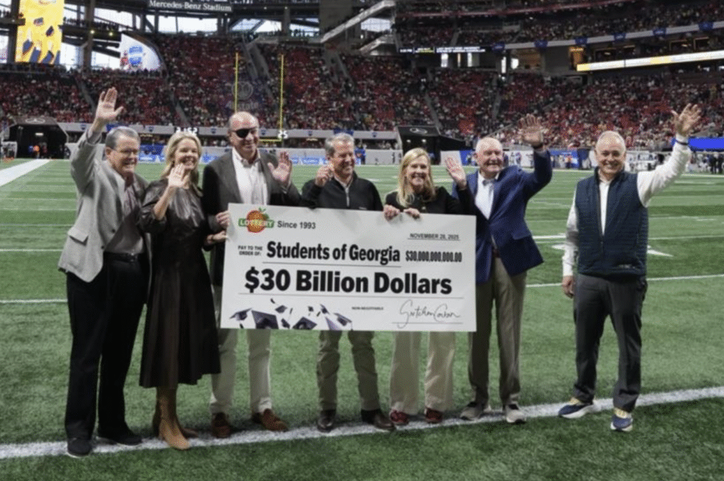 Image of Georgia officials at Mercedes Benz Stadium with a large check that says $30 billion to students of Georgia