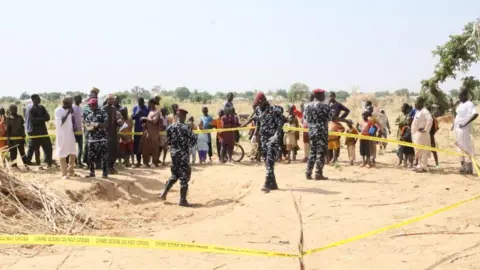 BBC Scene of a US strike in Jabo, in Sokoto state in north-west Nigeria, with police cordoning off a crater in a field, 26 December
