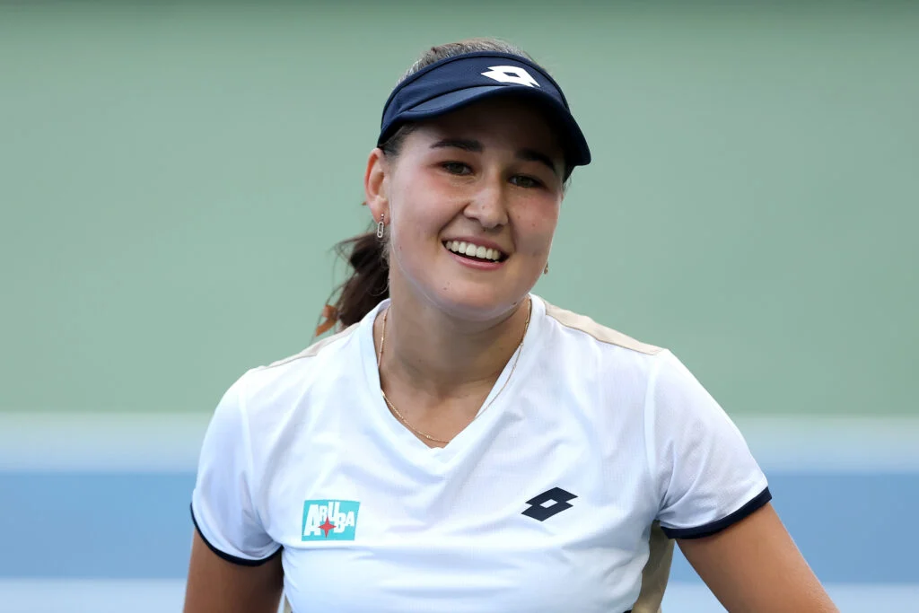 Kamilla Rakhimova smiles during her match against Daria Kasatkina at the 2025 US Open.