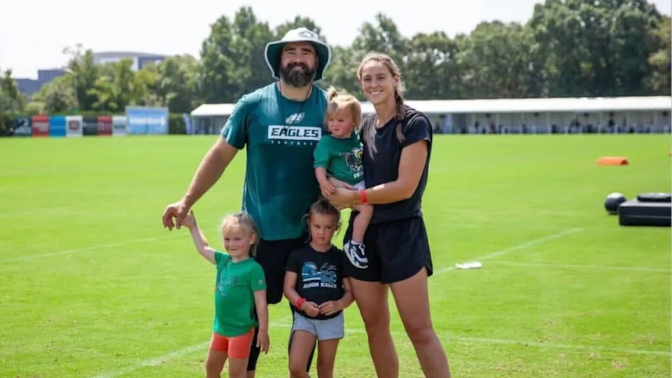 Jason Kelce and his wife Kylie with their 3 children enjoying a sunny day on the Eagles training field