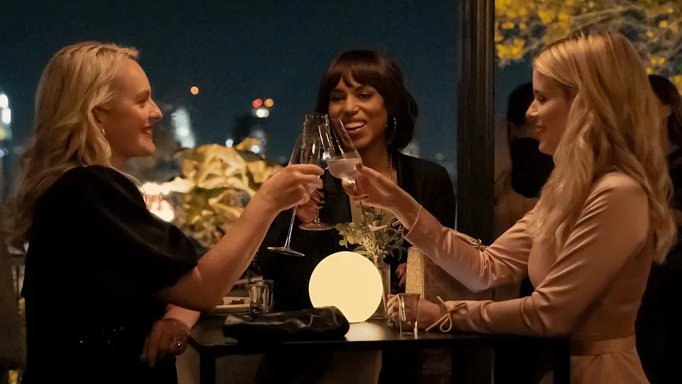 women toasting glasses at an evening gathering