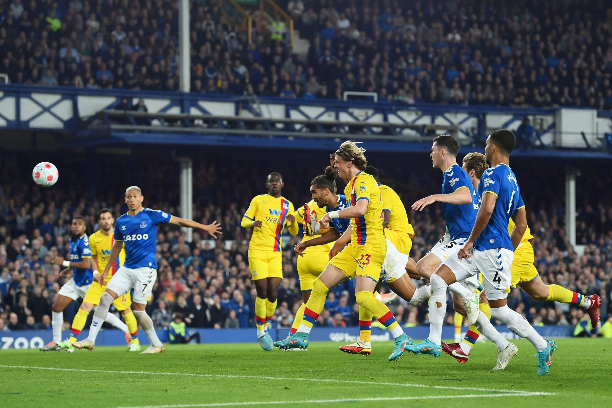 Dominic Calvert-Lewin dives between Crystal Palace players to head home Everton's critical winner in May 2022