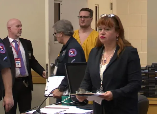 Dr. Michael David McKee, 39, of Chicago, who faces aggravated murder charges in Columbus, Ohio, enters a courtroom Monday, Jan. 12, 2026, at the Winnebago County Criminal Justice Center in Rockford.