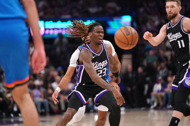 Mar 25, 2025; Sacramento, California, USA; Sacramento Kings guard Keon Ellis (23) has the ball knocked out of his hands by Oklahoma City Thunder guard Isaiah Joe (11) in the second quarter at the Golden 1 Center. Mandatory Credit: Cary Edmondson-Imagn Images