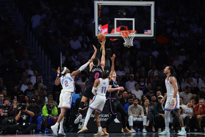 Jan 17, 2026; Miami, Florida, USA; Miami Heat forward Simone Fontecchio (0) drives to the basket against Oklahoma City Thunder guard Shai Gilgeous-Alexander (2) and guard Isaiah Joe (11) during the second quarter at Kaseya Center. Mandatory Credit: Sam Navarro-Imagn Images