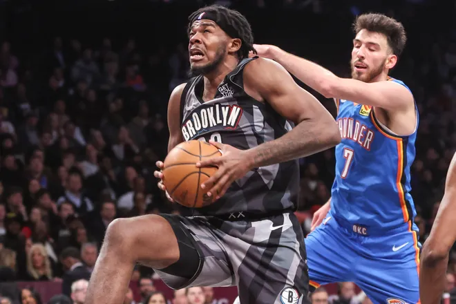 Feb 26, 2025; Brooklyn, New York, USA; Brooklyn Nets center Day'Ron Sharpe (20) grabs a rebound in the fourth quarter against the Oklahoma City Thunder at Barclays Center. Mandatory Credit: Wendell Cruz-Imagn Images