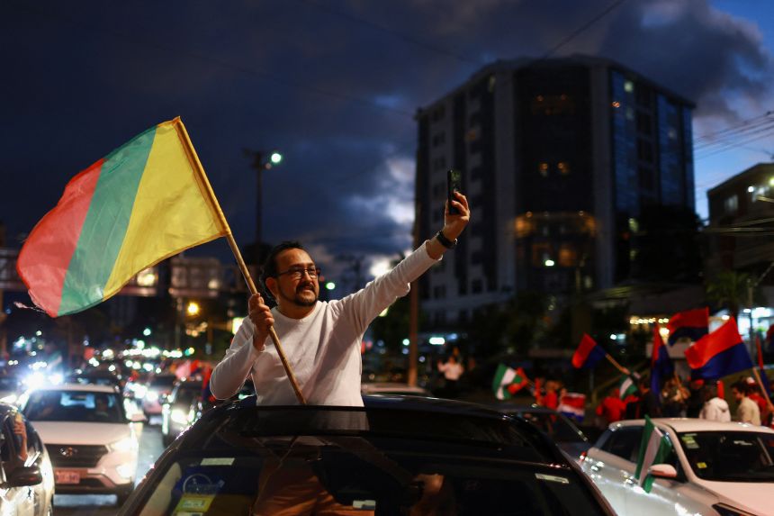 A supporter of Costa Rica presidential candidate Claudia Dobles of Citizen Agenda Coalition waves a flag in San José, Costa Rica.