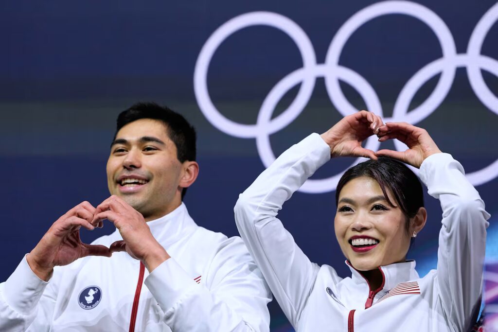 Emily Chan (right) and Spencer Akira Howe of the United States react to their scores after  pairs short program Sunday.