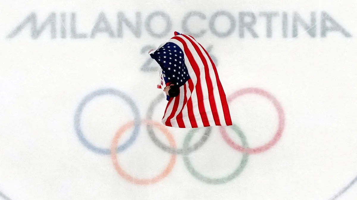 Connor Hellebuyck with the flag