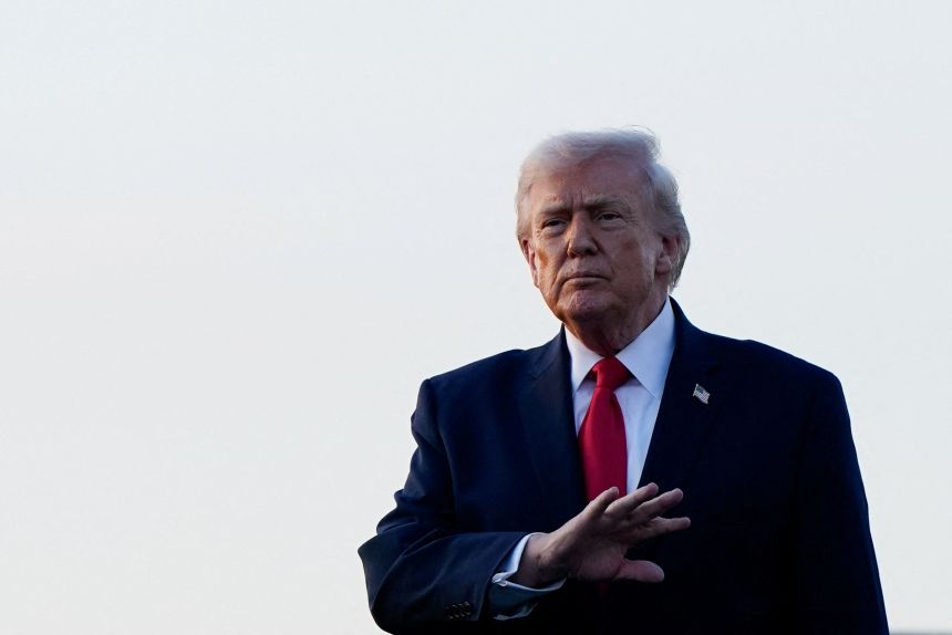 President Donald Trump gestures as he arrives at Palm Beach International Airport in West Palm Beach, Florida, on Friday.