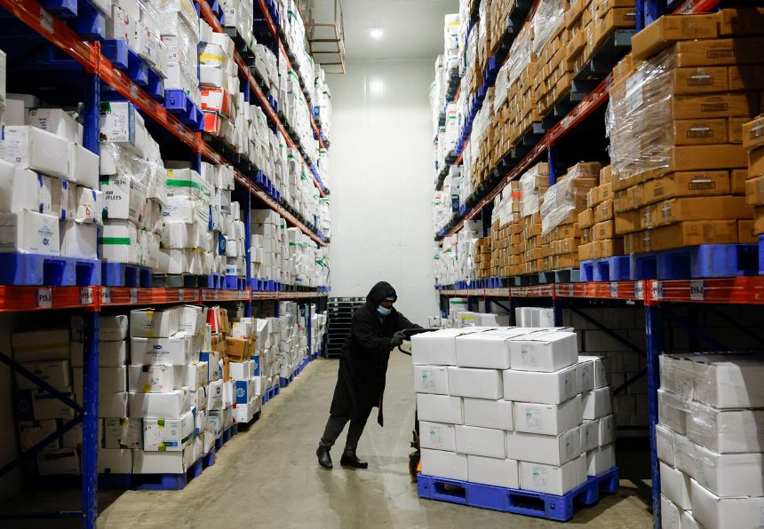 A worker pushes a cart of packaged frozen shrimps inside a cold storage unit at a shrimp factory situated on the outskirts of Vishakhapatnam, India, April 10, 2025.