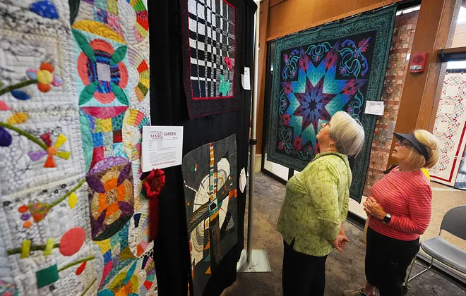 Visitors enjoy looking around the Garden Quilt Show on March 21, 2026, at Reiman Gardens in Ames, Iowa.