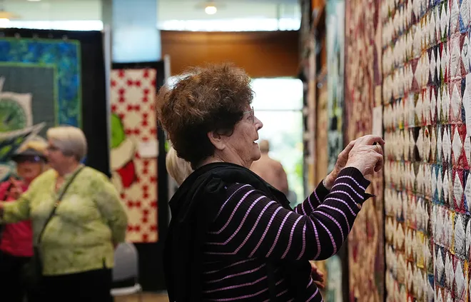 A visitor looks around the Garden Quilt Show on March 21, 2026, at Reiman Gardens in Ames, Iowa.