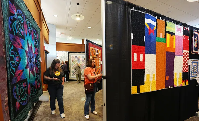 Visitors enjoy looking around the Garden Quilt Show on March 21, 2026, at Reiman Garden in Ames, Iowa.