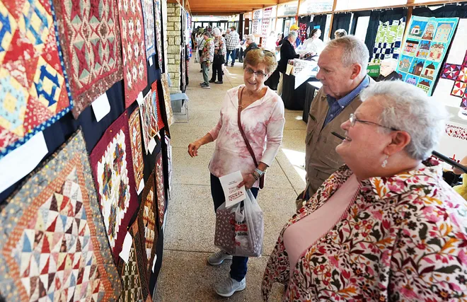 (From left) Barbara and Lesly North from Ames and Sandi Putsch of Harlan look around the Garden Quilt Show on March 21, 2026, at Reiman Gardens in Ames, Iowa.