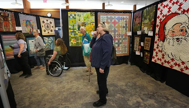 Visitors enjoy looking around the Garden Quilt Show on March 21, 2026, at Reiman Gardens in Ames, Iowa.