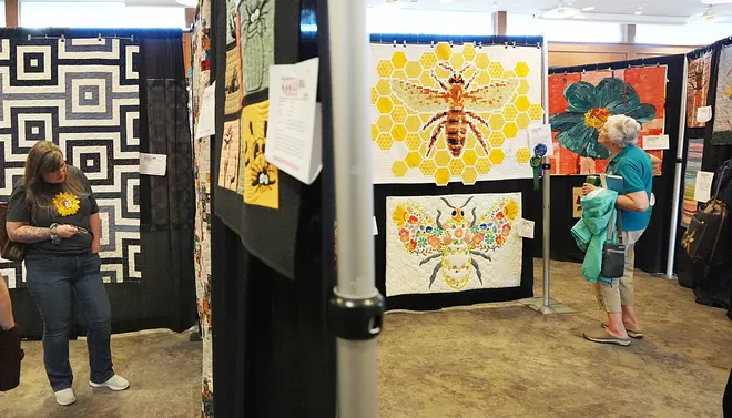 Visitors look around the Garden Quilt Show on March 21, 2026, at Reiman Garden in Ames, Iowa.