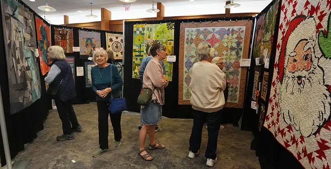 Visitors enjoy looking around the Garden Quilt Show on March 21, 2026, at Reiman Gardens in Ames, Iowa.