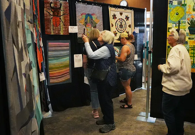 Visitors enjoy looking around the Garden Quilt Show on March 21, 2026, at Reiman Gardens in Ames, Iowa.