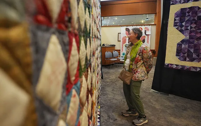 A visitor enjoys around the Garden Quilt Show on March 21, 2026, at Reiman Gardens in Ames, Iowa.
