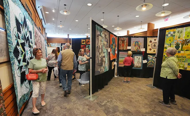 Visitors enjoy looking around the Garden Quilt Show on March 21, 2026, at Reiman Gardens in Ames, Iowa.