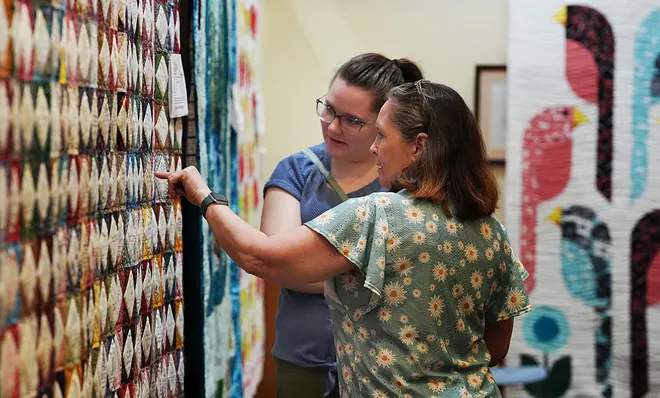 Jennifer Wille and Dennis Fields from Story City look around the Garden Quilt Show on March 21, 2026, at Reiman Gardens in Ames, Iowa.