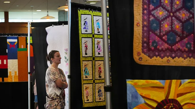 A vsitor looks around the Garden Quilt Show on March 21, 2026, at Reiman Gardens in Ames, Iowa.