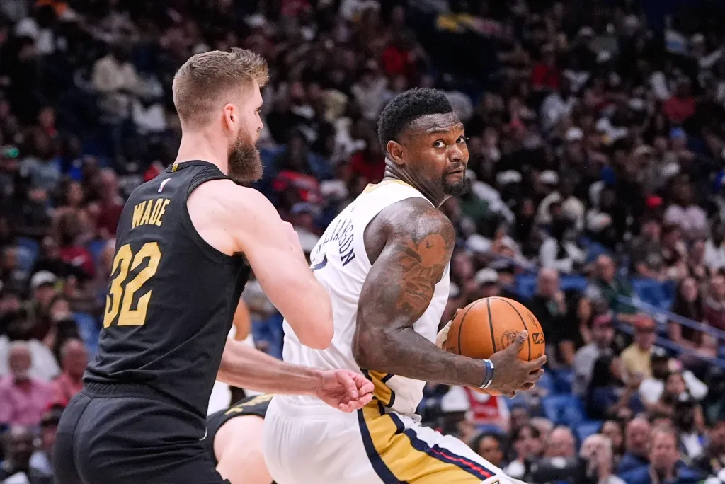 Zion Williamson looks to go to the basket against Cleveland Cavaliers forward Dean Wade (32) in the second half of an NBA basketball game, Saturday, March 21, 2026, in New Orleans.