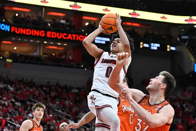 Jan 24, 2026; Louisville, Kentucky, USA; Louisville Cardinals guard Mikel Brown Jr. (0) shoots against Virginia Tech Hokies center Christian Gurdak (32) during the second half at KFC Yum! Center. Louisville defeated Virginia Tech 85-71. Mandatory Credit: Jamie Rhodes-Imagn Images