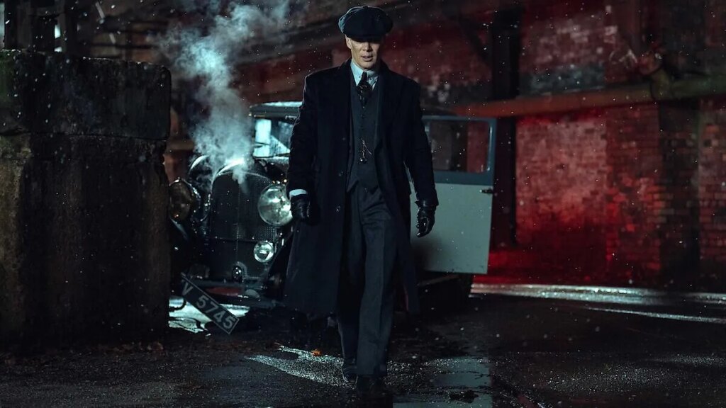Cillian Murphy as Tommy Shelby, walking away from a crashed period car, in Peaky Blinders: The Immortal Man.