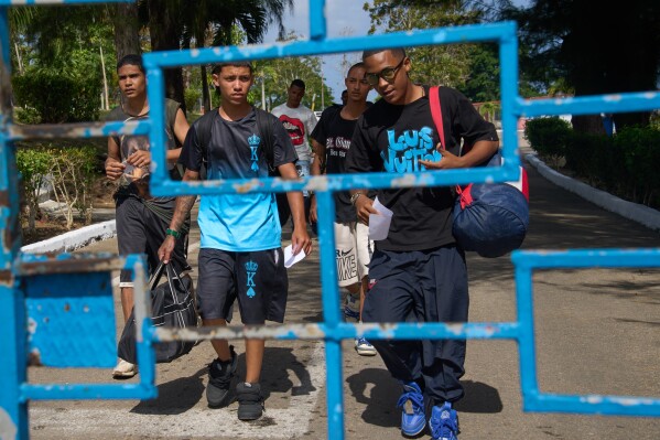 Damian Farinas, right, walks out of La Lima penitentiary alongside other pardoned prisoners after their release in Guanabacoa, Havana, Cuba, Friday, April 3, 2026. (AP Photo/Ramon Espinosa)