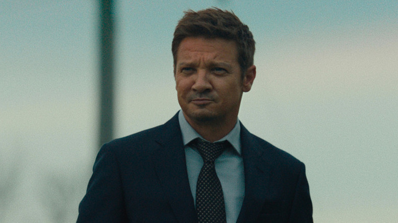 Mike McLusky (Jeremy Renner) stands smirking in Mayor of Kingstown