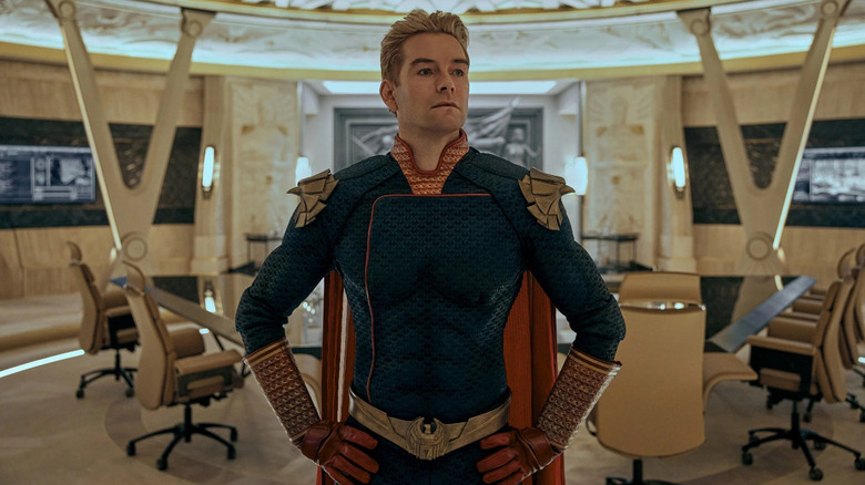 Homelander (Antony Starr) stands triumphantly in a conference room in The Boys