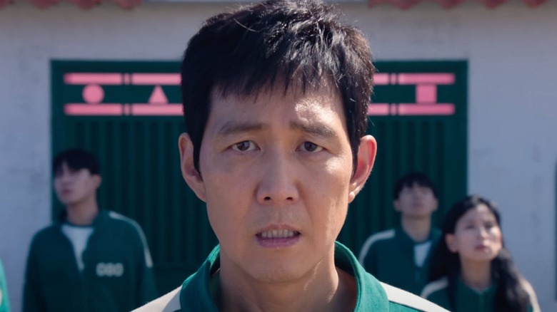 Seong Gi-hun (Lee Jung-jae) grimaces in Squid Game