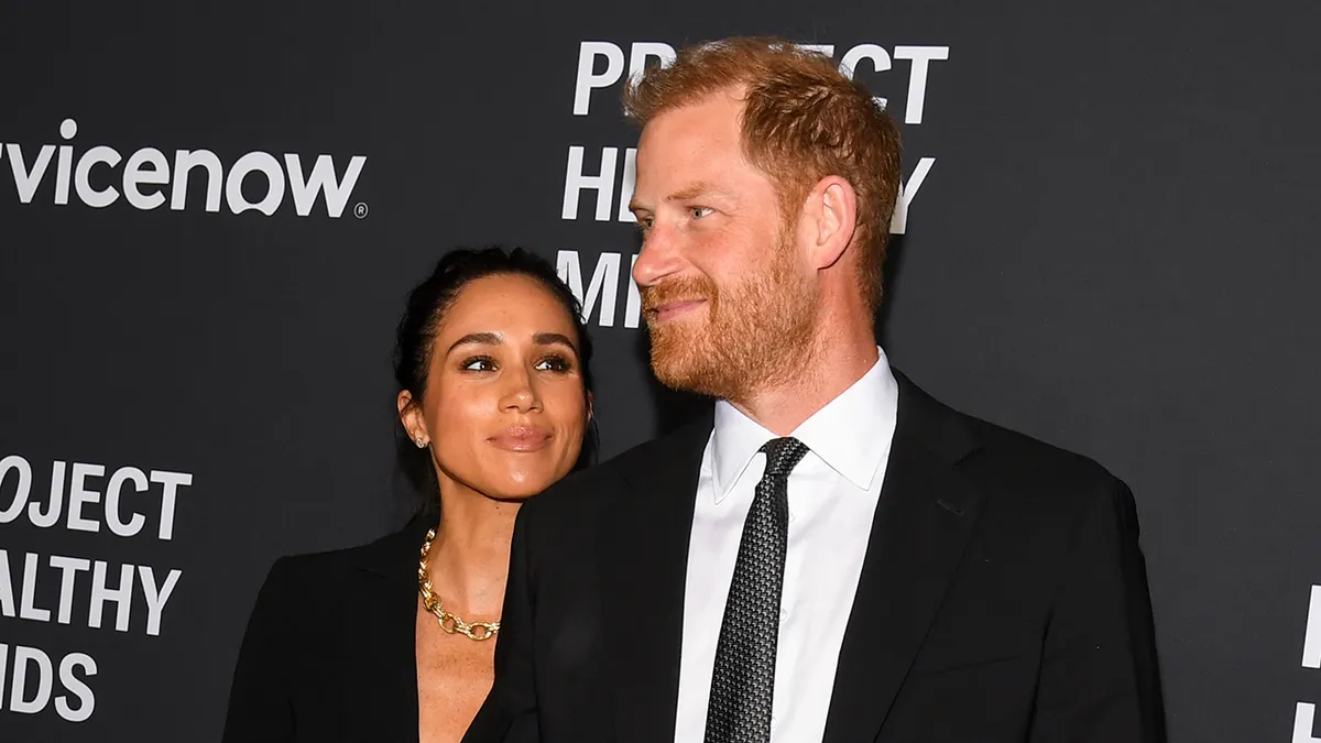Meghan, Duchess of Sussex, and Prince Harry, Duke of Sussex, standing together at an event.