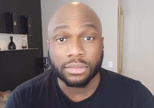 A bearded man in a black t-shirt