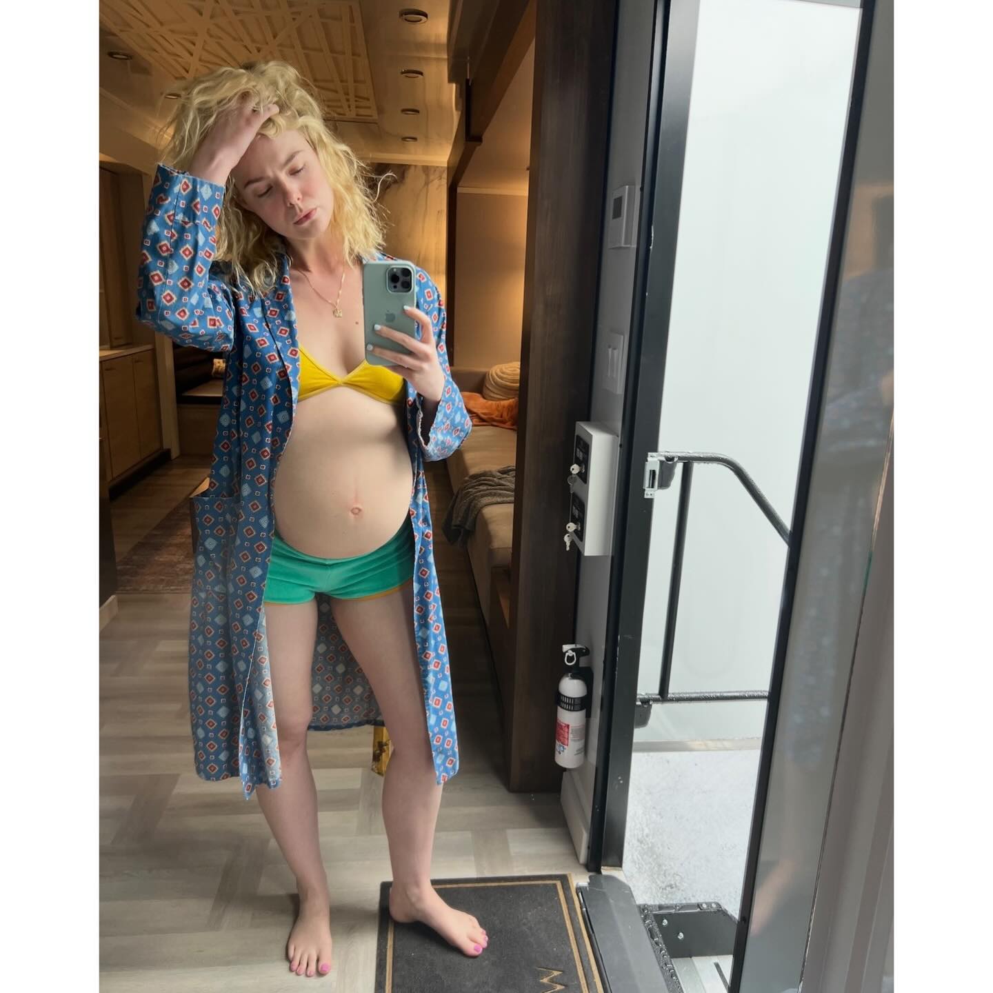 Elle Fanning, dressed as her pregnant character  in the Apple TV show “Margo’s Got Money Troubles,” shows off her prosthetic baby bump.