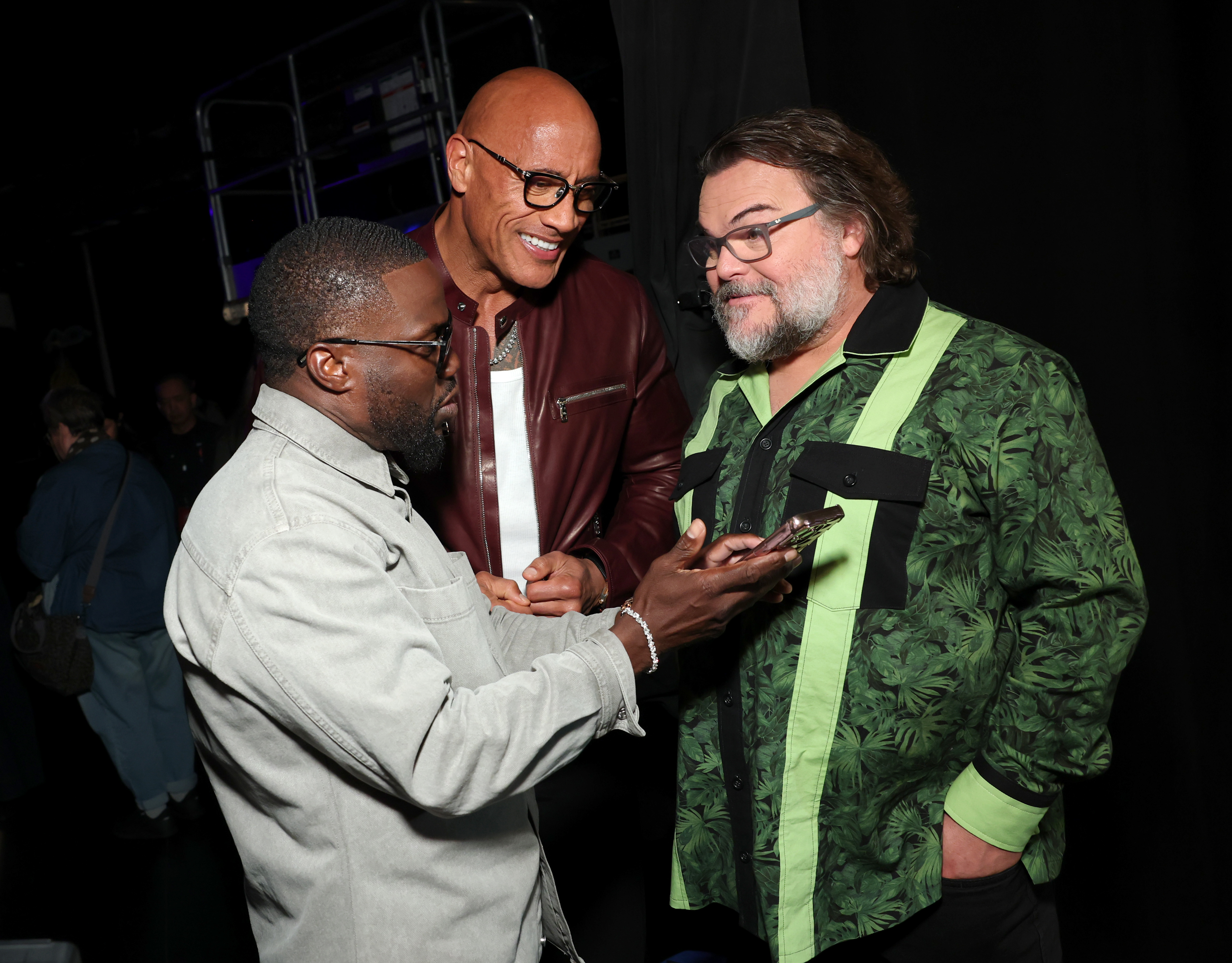 Kevin Hart (from left), Dwayne Johnson and Jack Black   look ready for prank calls at the screening their movie “Jumanji: Open World”  in Las Vegas.