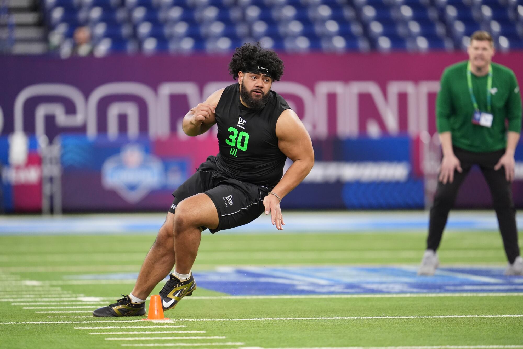 Penn State offensive lineman Olaivavega Ioane runs a drill at the NFL scouting combine in Indianapolis on March 1.