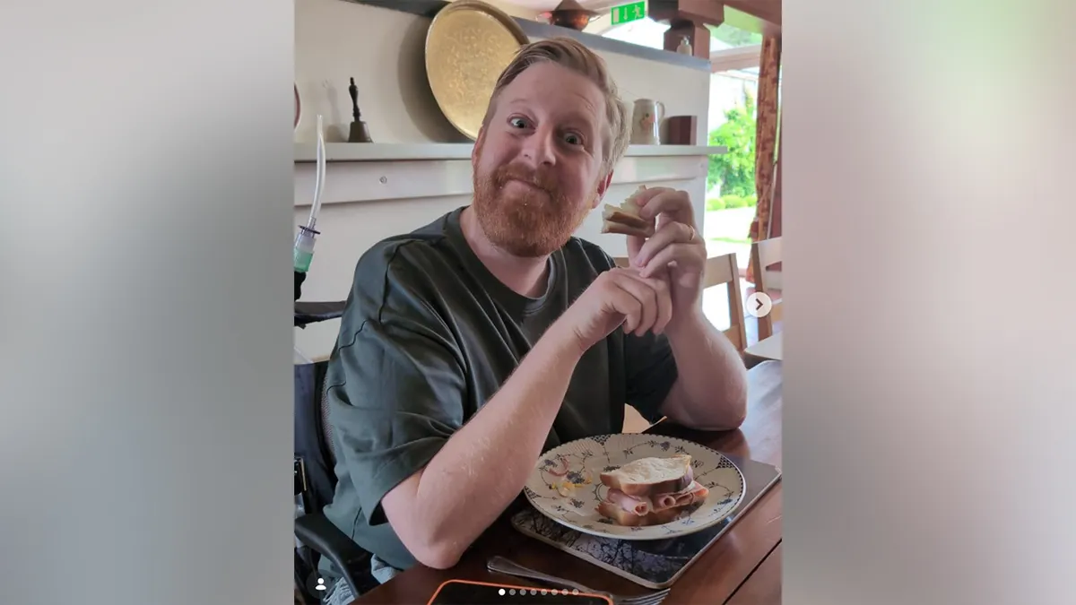 Michael Patrick eating a sandwich.
