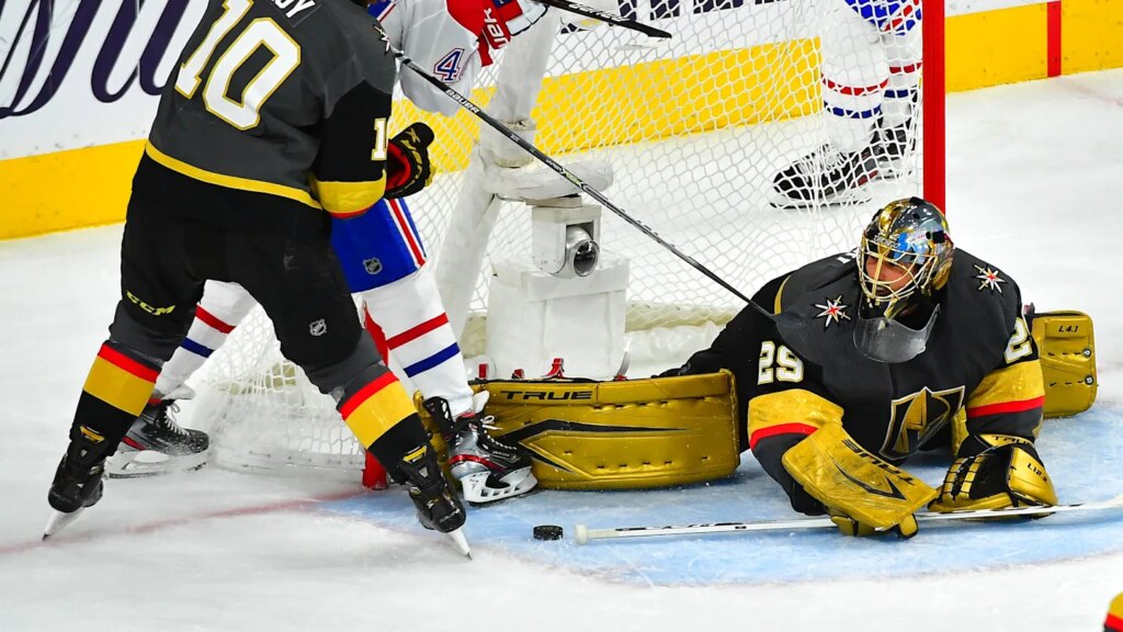 Jun 22, 2021; Las Vegas, Nevada, USA; Vegas Golden Knights center Nicolas Roy (10) checks Montreal Canadiens right wing Joel Armia (40) as goaltender Marc-Andre Fleury (29) keeps the puck out of his net during the second period of game five of the 2021 Stanley Cup Semifinals at T-Mobile Arena. Mandatory Credit: Stephen R. Sylvanie-Imagn Images