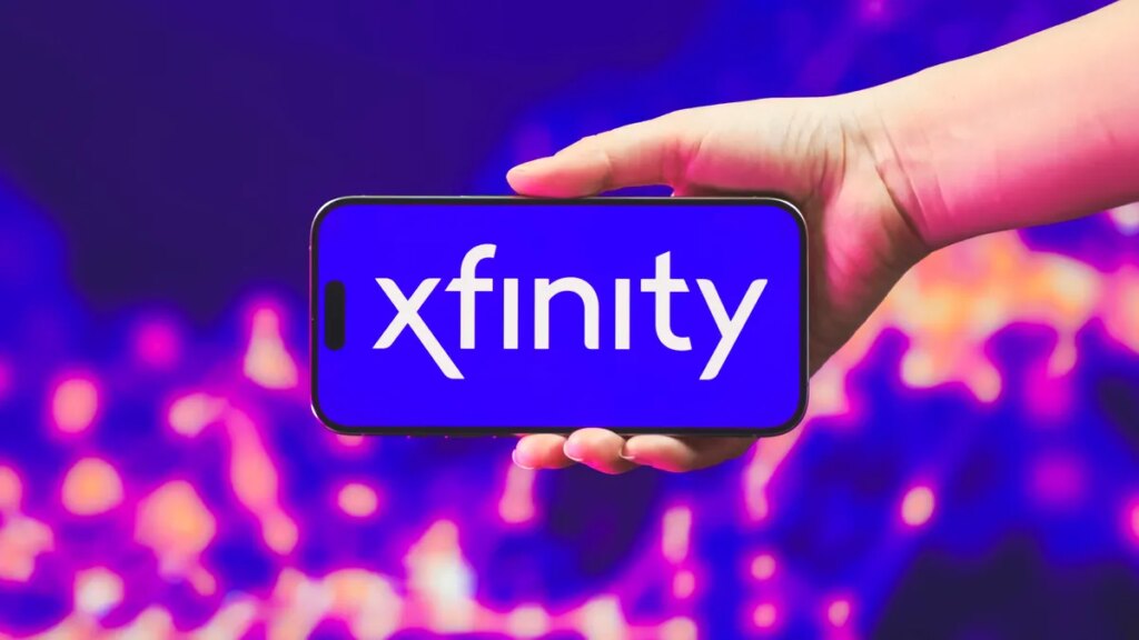 A hand holding a phone with the Xfinity logo on it.