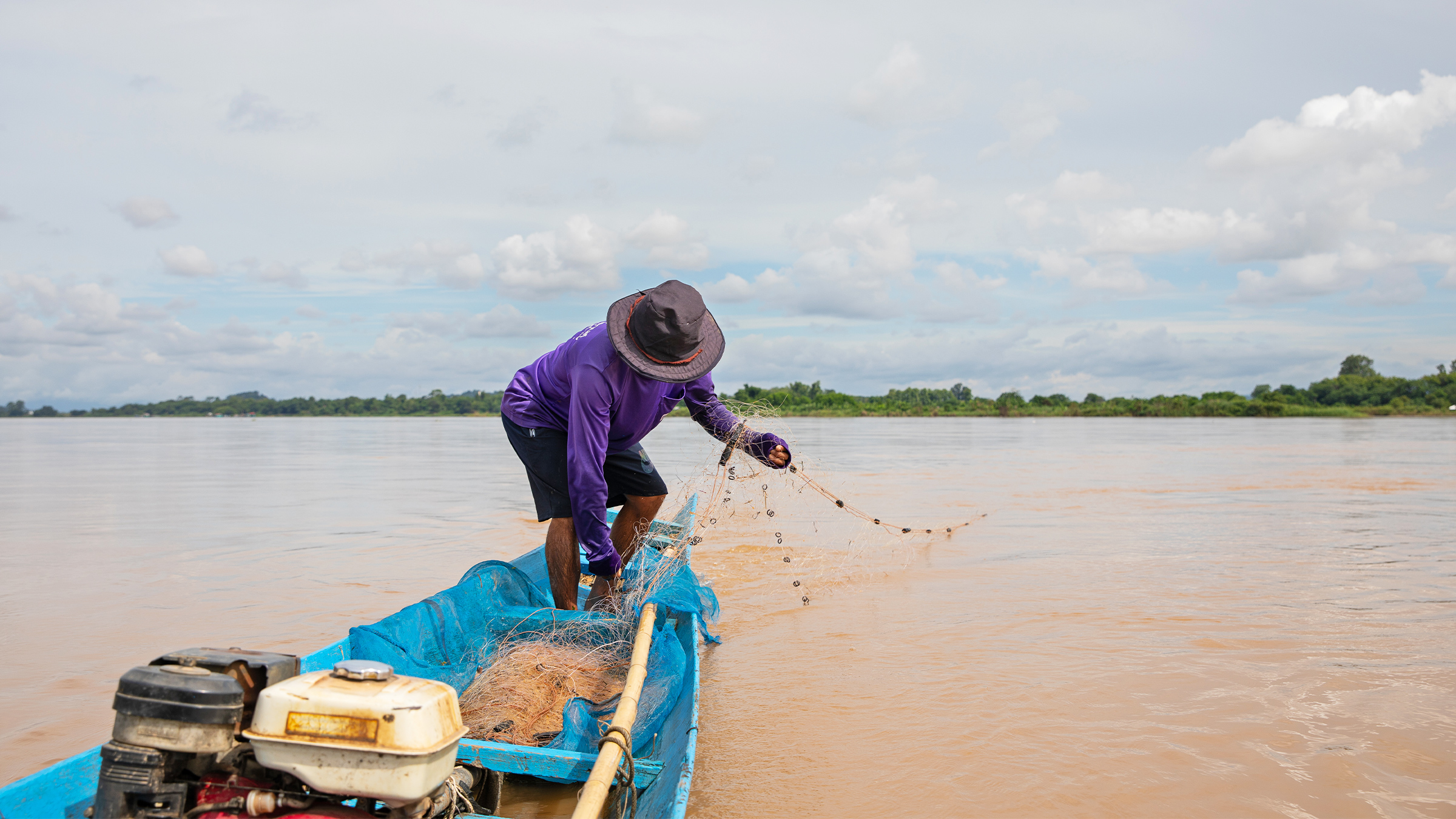 A fisherman feeds his net into the Mekong River on the Thai-Lao border by Chiang Saen.