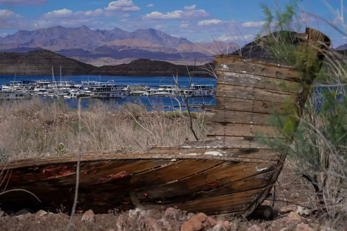 The remains of a boat sit out of the water at the Lake Mead National Recreation Area on Wednesday, Apr. 01, 2026, Boulder City, Nev. (AP Photo/Ty ONeil)