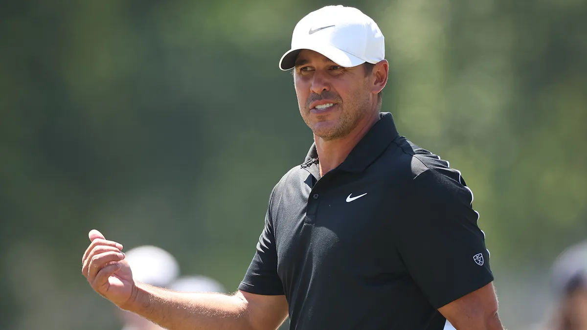 Brooks Koepka reacting on the fifth green during golf tournament round.