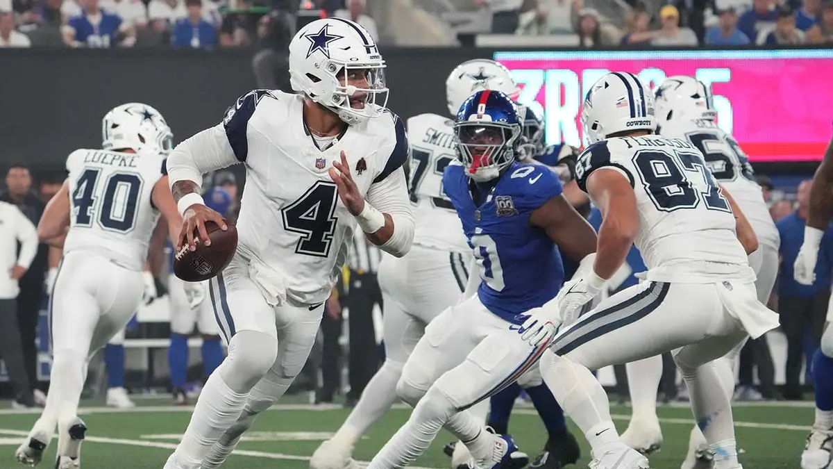 Dallas Cowboys quarterback Dak Prescott rolling out during a game at MetLife Stadium