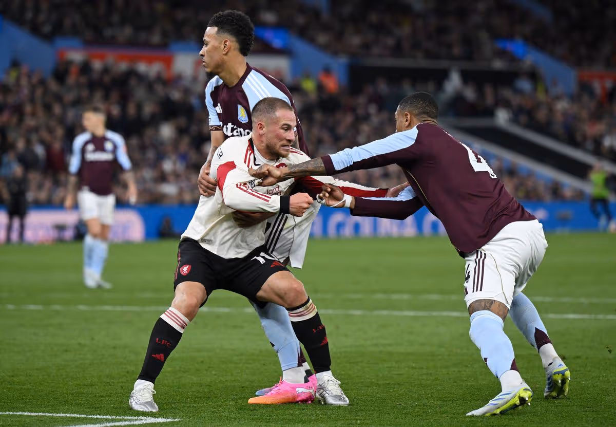BIRMINGHAM, ENGLAND - MAY 15: Ezri Konsa of Aston Villa has his shirt ripped as he battles for position with Alexis Mac Allister of Liverpool during the Premier League match between Aston Villa and Liverpool at Villa Park on May 15, 2026 in Birmingham, England. (Photo by Shaun Botterill/Getty Images)