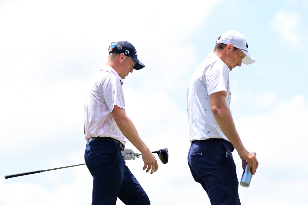 Jordan Spieth and Justin Thomas walk off the tee during the first round of the Cadillac Championship