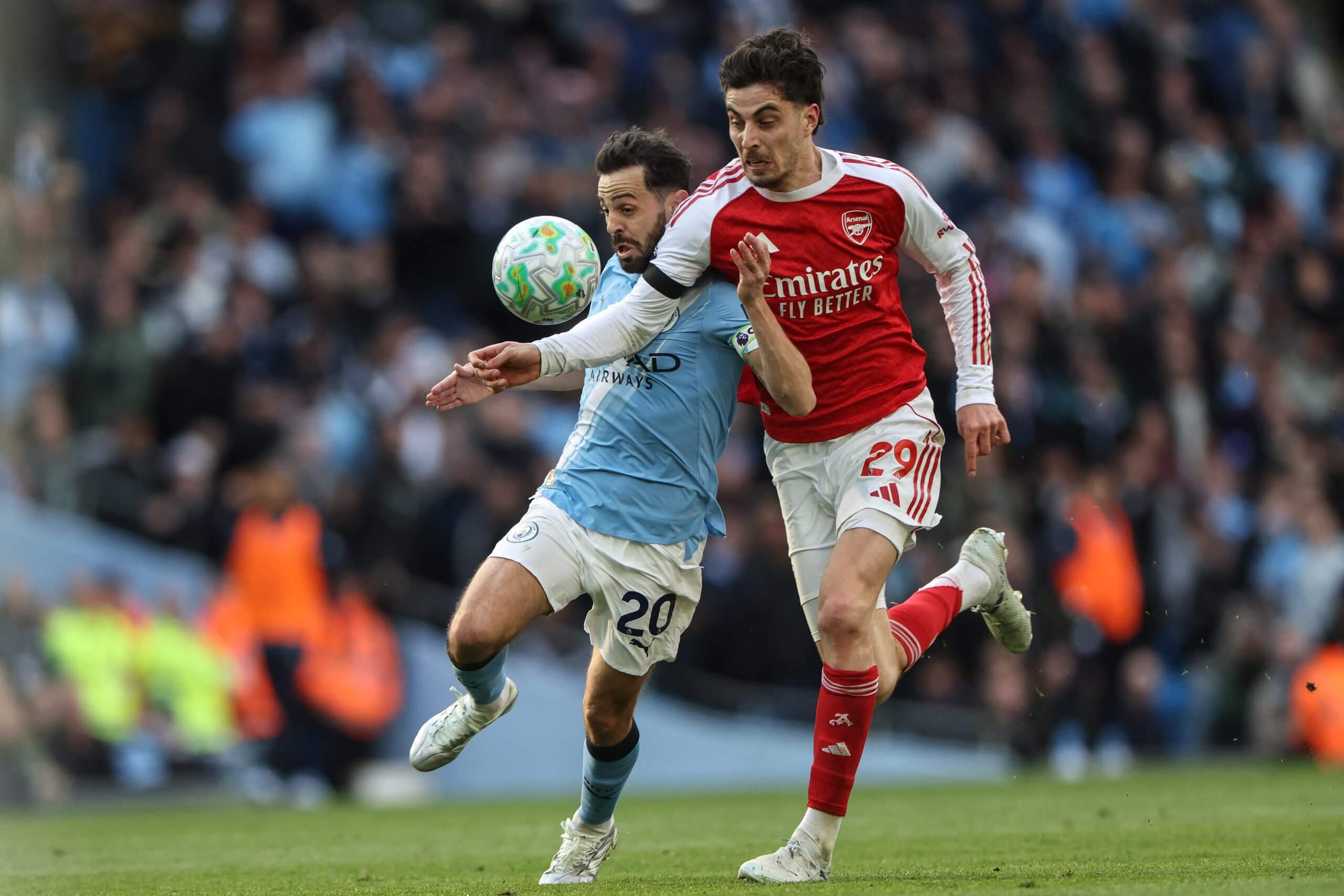 Manchester City's Bernardo Silva is challenged by Arsenal's Kai Havertz