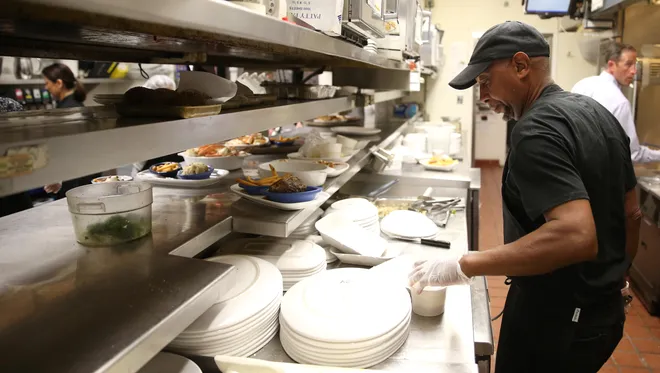 Horace Williams works in the kitchen at Red Lobster Wednesday where he is currently a head cook and has been employed for 45 years. Williams, who started work at the restaurant as a 17-year-old, officially retired from his post Thursday.
